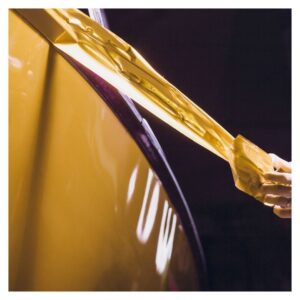 Pulling off excess of a yellow wrap on a vehicle