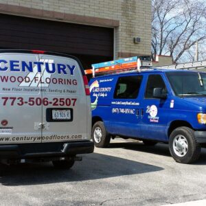 two work trucks wrapped by sign central