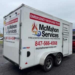 A commercial service van featuring a colorful, full-body branding wrap driving through a residential neighborhood.